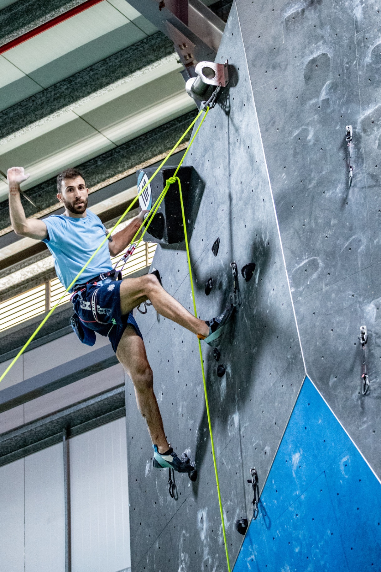Amputee climber on a competition lead wall