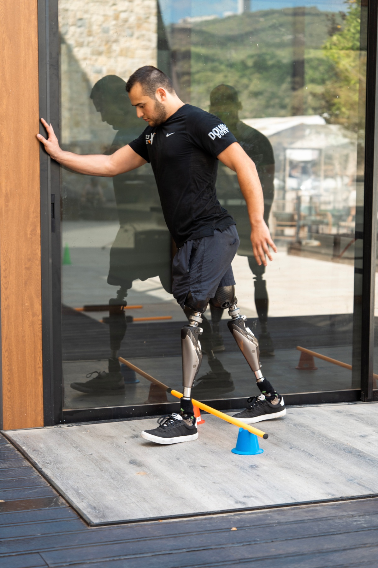 Double amputee practicing balance and walking drills