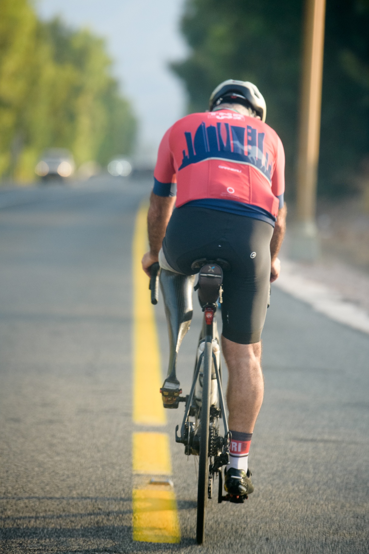 Amputee cyclist on the road with a prosthetic leg