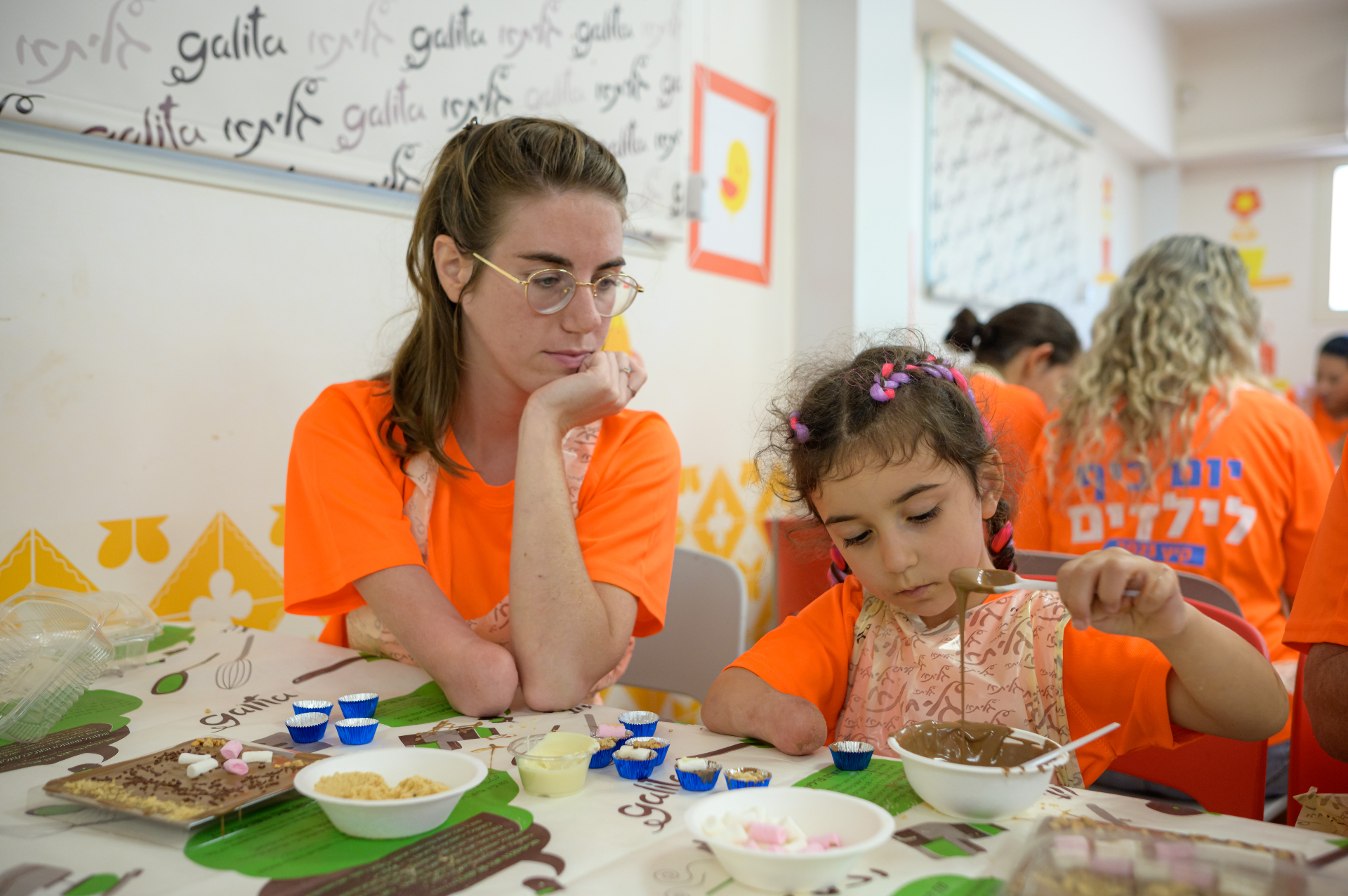A child and mentor at a hands-on workshop
