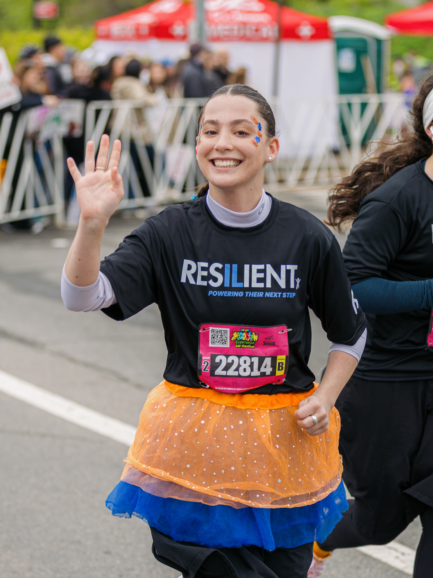 Resilient team racer waving on course