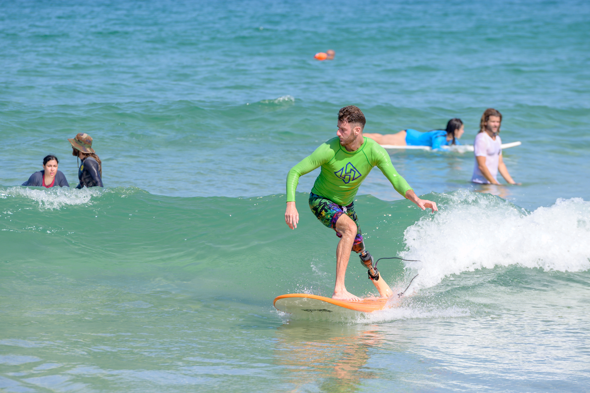 An amputee surfing a wave in Israel
